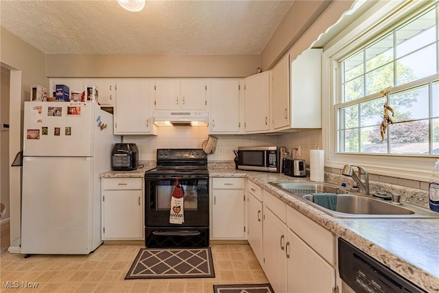 530 N Scranton St, Ravenna, OH 44266 - kitchen with freestanding refrigerator, black range with electric stovetop, under cabinet range hood, stainless steel microwave, and dishwashing machine