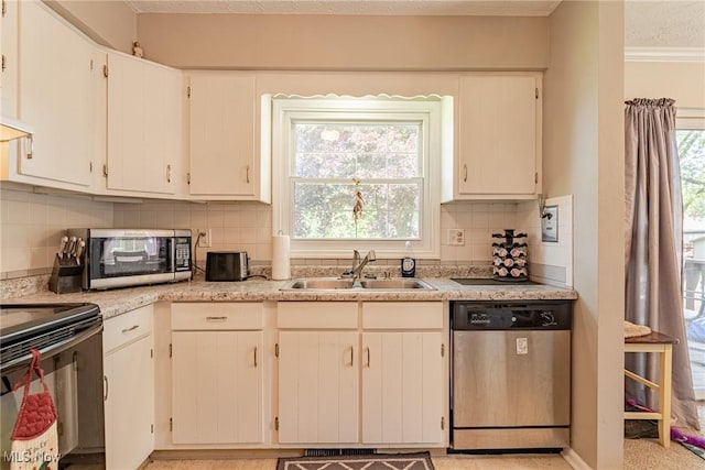 530 N Scranton St, Ravenna, OH 44266 - kitchen featuring stainless steel appliances, light countertops, backsplash, white cabinetry, and ornamental molding