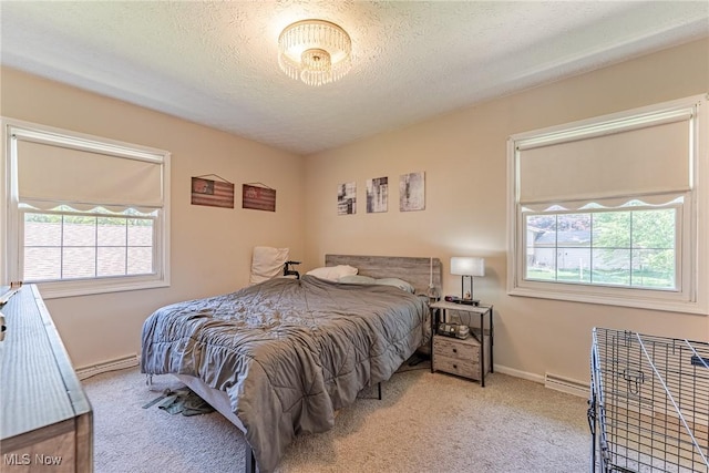530 N Scranton St, Ravenna, OH 44266 - bedroom with a baseboard heating unit, carpet floors, and a textured ceiling