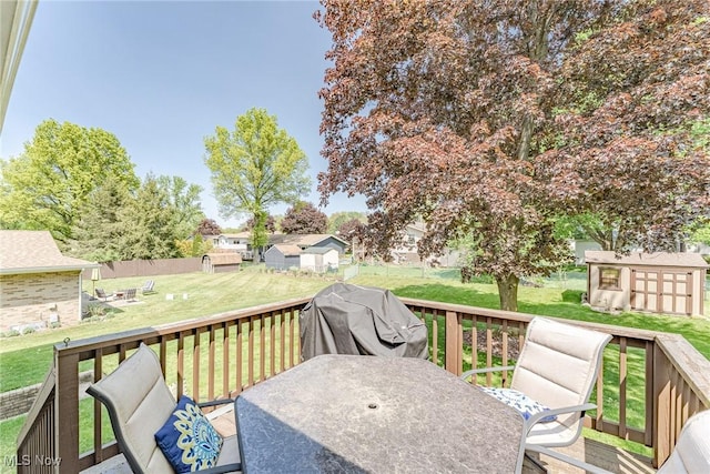 530 N Scranton St, Ravenna, OH 44266 - wooden deck featuring a shed, a grill, outdoor dining area, and a lawn