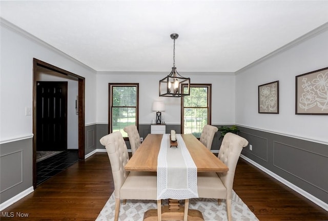 1593 Stonington Dr, Hudson, OH 44236 - dining area featuring crown molding, wainscoting, dark wood-type flooring, a decorative wall, and a chandelier