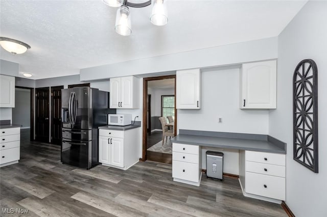 1593 Stonington Dr, Hudson, OH 44236 - kitchen with refrigerator with ice dispenser, white microwave, dark countertops, white cabinetry, and dark wood-style flooring