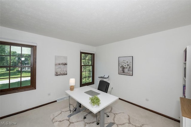 1593 Stonington Dr, Hudson, OH 44236 - office area with light colored carpet, healthy amount of natural light, and a textured ceiling