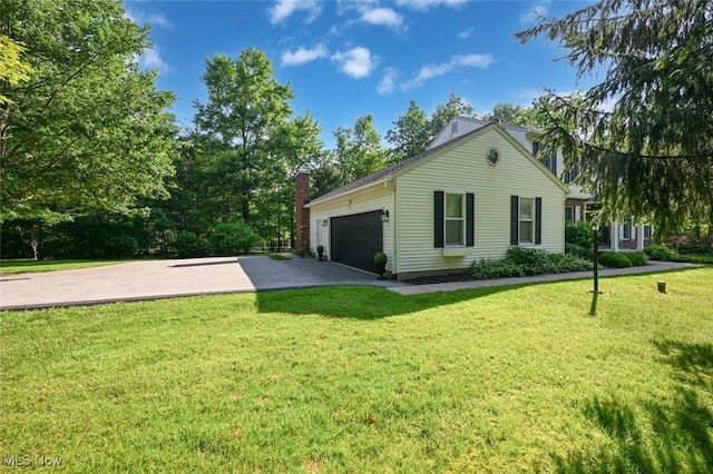 1593 Stonington Dr, Hudson, OH 44236 - view of property exterior with an attached garage, driveway, a yard, and a chimney