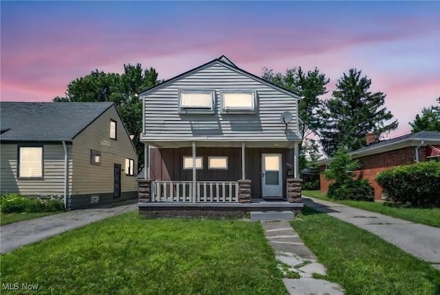 11113 Avon Ave, Cleveland, OH 44105 - view of front of house with a porch, board and batten siding, and a front yard