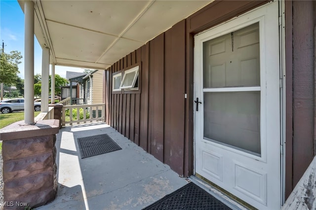 11113 Avon Ave, Cleveland, OH 44105 - doorway to property featuring board and batten siding and a porch
