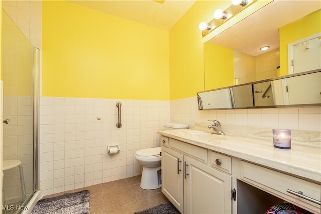 2112 Acacia Park Dr Unit 220, Lyndhurst, OH 44124 - bathroom featuring vanity, tile walls, tile patterned flooring, a shower stall, and a wainscoted wall