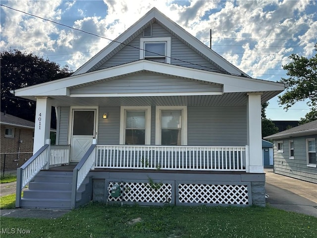 4011 E 29th St, Newburgh Heights, OH 44105 - shotgun-style home with a porch