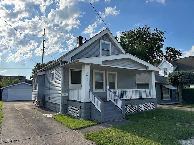 4011 E 29th St, Newburgh Heights, OH 44105 - bungalow with a porch, an outbuilding, a garage, a front yard, and a chimney