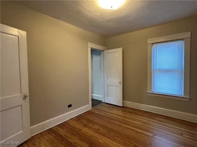 4011 E 29th St, Newburgh Heights, OH 44105 - unfurnished bedroom featuring baseboards and wood finished floors