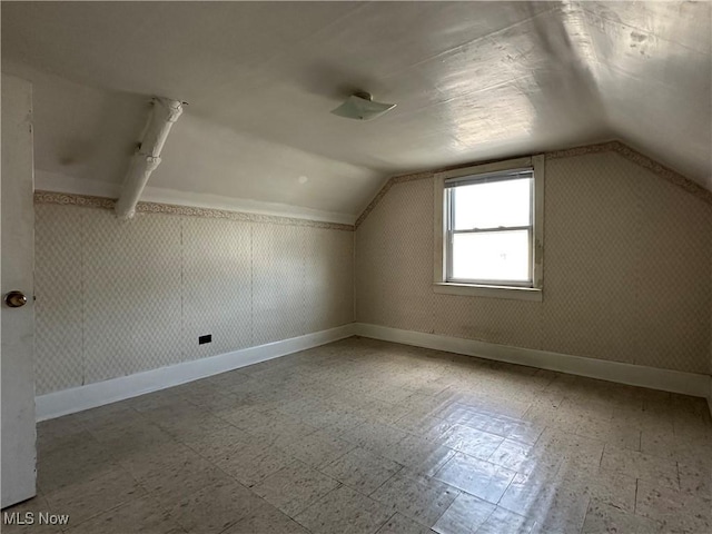 4011 E 29th St, Newburgh Heights, OH 44105 - additional living space featuring tile patterned floors and vaulted ceiling