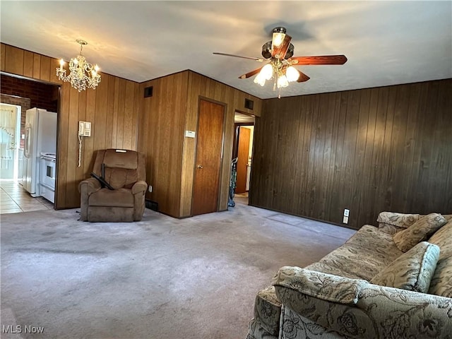 4013 E 29th St, Newburgh Heights, OH 44105 - living area featuring a chandelier, wooden walls, light colored carpet, and ceiling fan