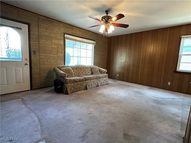4013 E 29th St, Newburgh Heights, OH 44105 - living room featuring plenty of natural light, ceiling fan, wooden walls, and light carpet