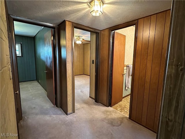 4013 E 29th St, Newburgh Heights, OH 44105 - hall featuring a textured ceiling, carpet floors, and wood walls