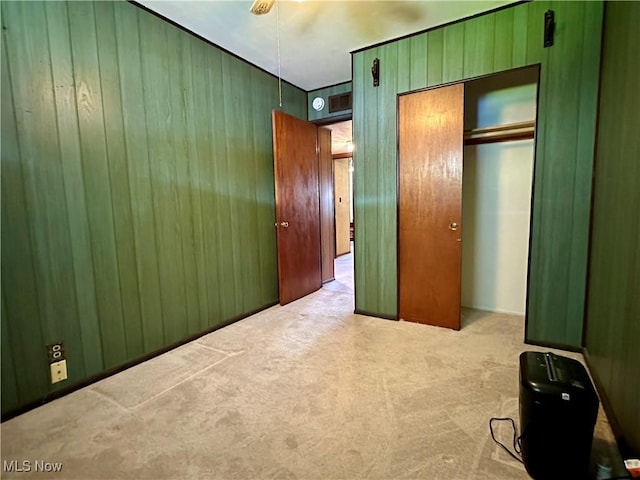 4013 E 29th St, Newburgh Heights, OH 44105 - unfurnished bedroom featuring carpet, wooden walls, and a closet