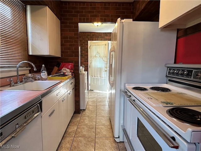 4013 E 29th St, Newburgh Heights, OH 44105 - kitchen featuring electric range, dishwasher, white cabinets, light tile patterned floors, and washer / clothes dryer