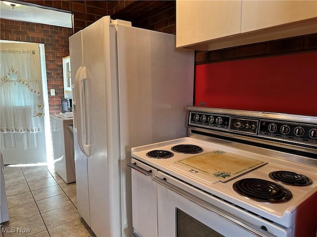 4013 E 29th St, Newburgh Heights, OH 44105 - kitchen with white electric stove, washer / clothes dryer, and light tile patterned floors