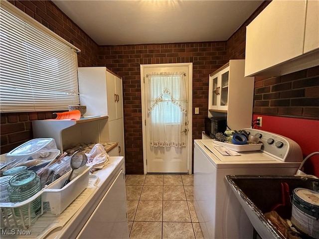 4013 E 29th St, Newburgh Heights, OH 44105 - laundry room featuring brick wall and light tile patterned floors