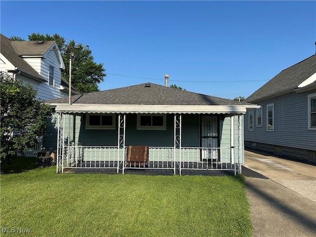 4013 E 29th St, Newburgh Heights, OH 44105 - view of front of home featuring a front yard, covered porch, and a shingled roof
