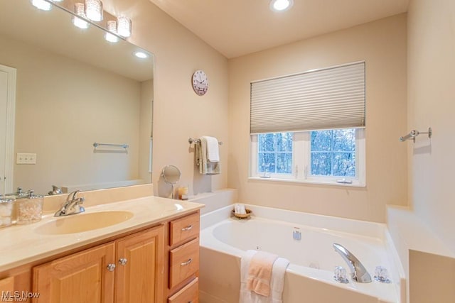 8121 Hitchcock Rd Unit 11, Boardman, OH 44512 - bathroom featuring a tub with jets, vanity, and recessed lighting