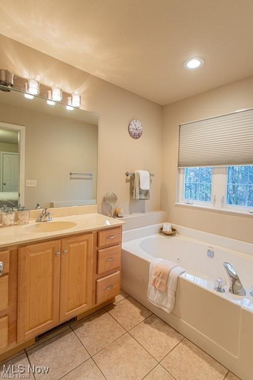8121 Hitchcock Rd Unit 11, Boardman, OH 44512 - bathroom with a garden tub, vanity, tile patterned flooring, and recessed lighting