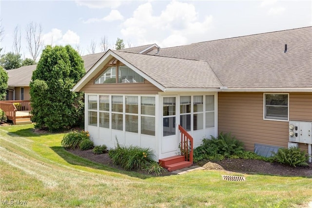 189 Park Place Dr, Wadsworth, OH 44281 - rear view of property with roof with shingles, a sunroom, and a yard