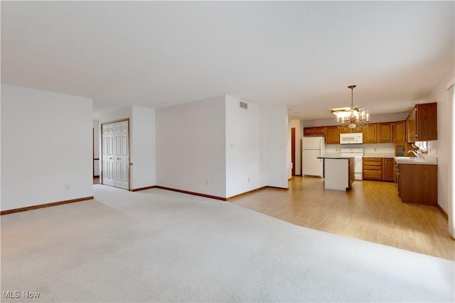 189 Park Place Dr, Wadsworth, OH 44281 - unfurnished living room featuring a chandelier and light carpet
