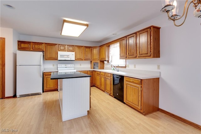 189 Park Place Dr, Wadsworth, OH 44281 - kitchen featuring white appliances, light wood-style floors, a kitchen island, and brown cabinets