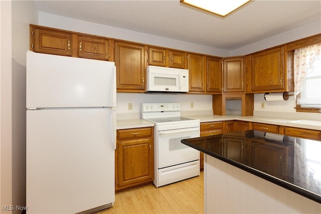 189 Park Place Dr, Wadsworth, OH 44281 - kitchen featuring white appliances, brown cabinetry, and light wood-type flooring
