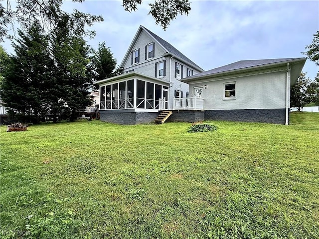 5519 4th Ave, Vienna, WV 26105 - rear view of house with a sunroom, a lawn, brick siding, and a wooden deck