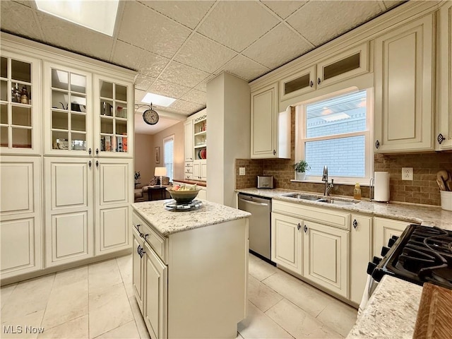 5519 4th Ave, Vienna, WV 26105 - kitchen with dishwasher, cream cabinets, decorative backsplash, and glass insert cabinets