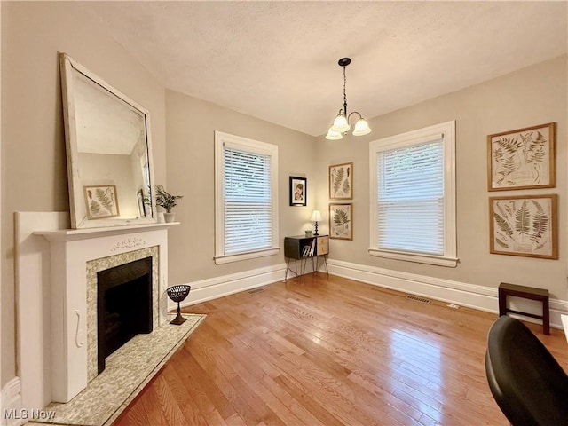 5519 4th Ave, Vienna, WV 26105 - living area with wood finished floors, a chandelier, a high end fireplace, and a textured ceiling