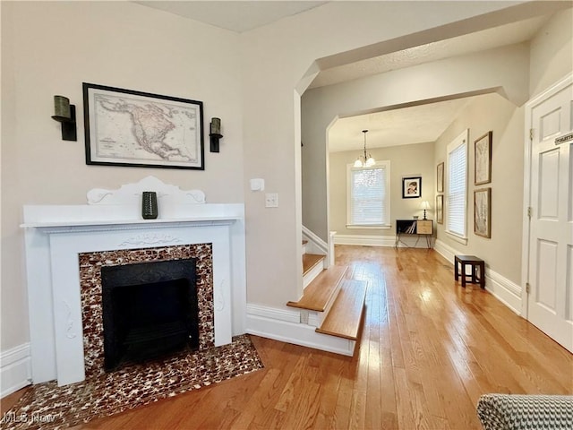 5519 4th Ave, Vienna, WV 26105 - living room featuring hardwood / wood-style floors, a chandelier, stairway, and a premium fireplace