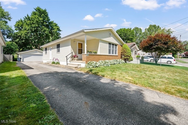 1586 Norledge Rd, Akron, OH 44305 - ranch-style home featuring an outdoor structure, brick siding, a front yard, and a detached garage