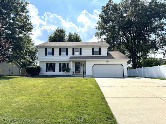 607 Wyndclift Cir, Austintown, OH 44515 - view of front facade with concrete driveway, a chimney, and an attached garage