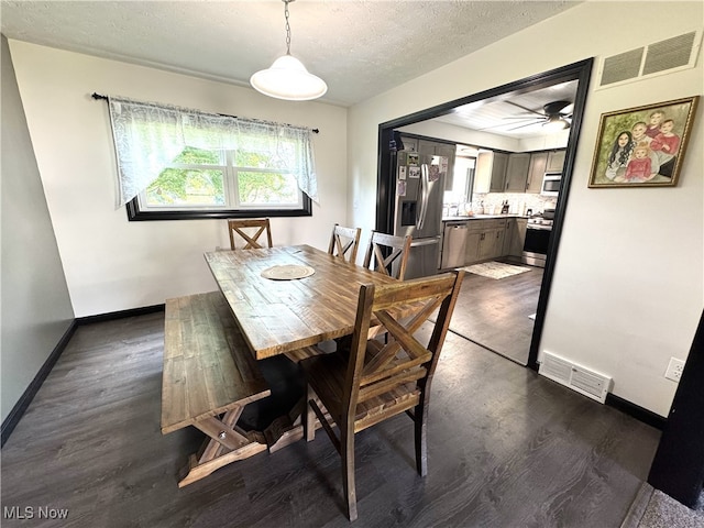 607 Wyndclift Cir, Austintown, OH 44515 - dining space with dark wood-style flooring, a textured ceiling, and a ceiling fan