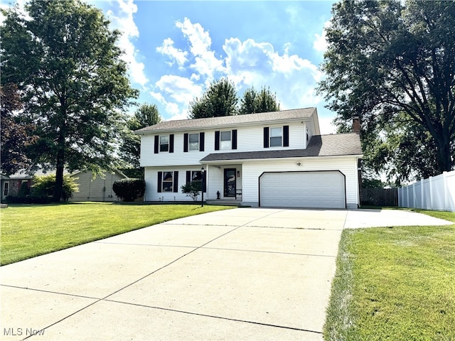 607 Wyndclift Cir, Austintown, OH 44515 - view of front facade featuring driveway, a chimney, and a garage
