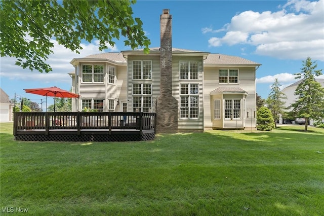 915 Cimarron Oval, Aurora, OH 44202 - rear view of house with a deck, a chimney, and a lawn