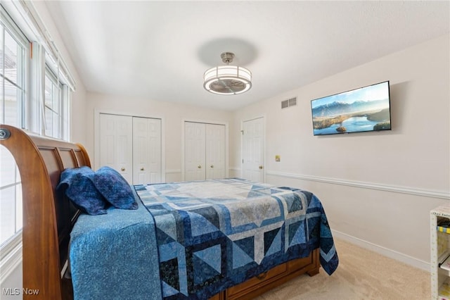 915 Cimarron Oval, Aurora, OH 44202 - carpeted bedroom with multiple closets and baseboards