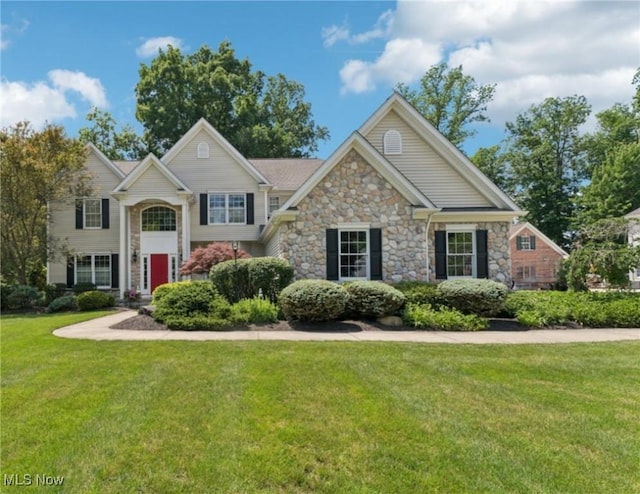 915 Cimarron Oval, Aurora, OH 44202 - view of front of property with stone siding and a front lawn