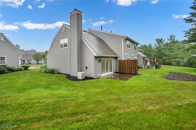 9543 Ridge Ct, Twinsburg, OH 44087 - rear view of house featuring a yard, a chimney, and roof with shingles