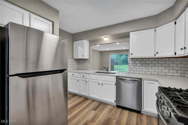 9543 Ridge Ct, Twinsburg, OH 44087 - kitchen featuring stainless steel appliances, light countertops, white cabinetry, and recessed lighting