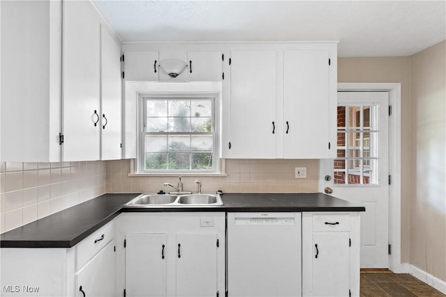 2016 Spring Ave NE, Canton, OH 44714 - kitchen with white dishwasher, dark countertops, white cabinetry, and backsplash