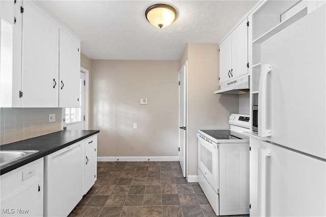 2016 Spring Ave NE, Canton, OH 44714 - kitchen featuring white appliances, under cabinet range hood, white cabinets, dark countertops, and backsplash