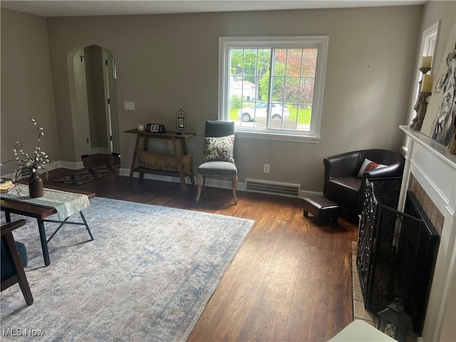 2016 Spring Ave NE, Canton, OH 44714 - living area with arched walkways, wood finished floors, and a fireplace