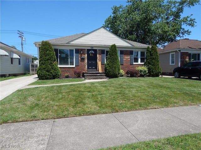 6012 Sunderland Dr, Parma, OH 44129 - view of front of home with brick siding and a front yard