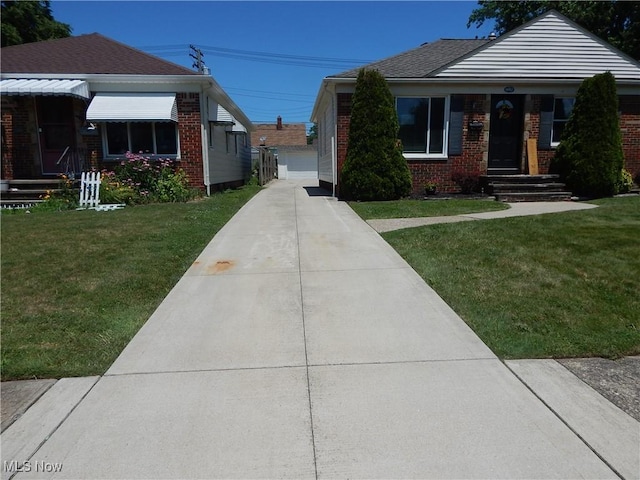 6012 Sunderland Dr, Parma, OH 44129 - bungalow-style house with brick siding, a front yard, a detached garage, and an outbuilding