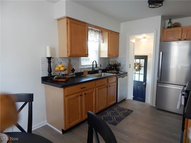 6012 Sunderland Dr, Parma, OH 44129 - kitchen with stainless steel appliances, wood finished floors, dark countertops, and tasteful backsplash