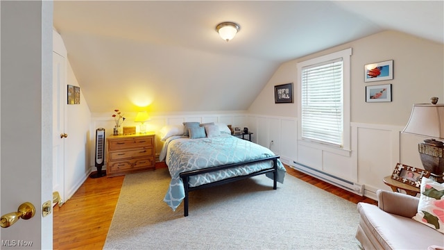 500 Elm St, Belpre, OH 45714 - bedroom with a baseboard heating unit, wood finished floors, lofted ceiling, and wainscoting