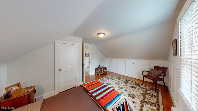 500 Elm St, Belpre, OH 45714 - bedroom featuring multiple windows, vaulted ceiling, and wood finished floors